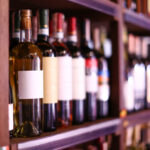 Rack with bottles of wine in store